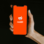 person holding phone with reddit app